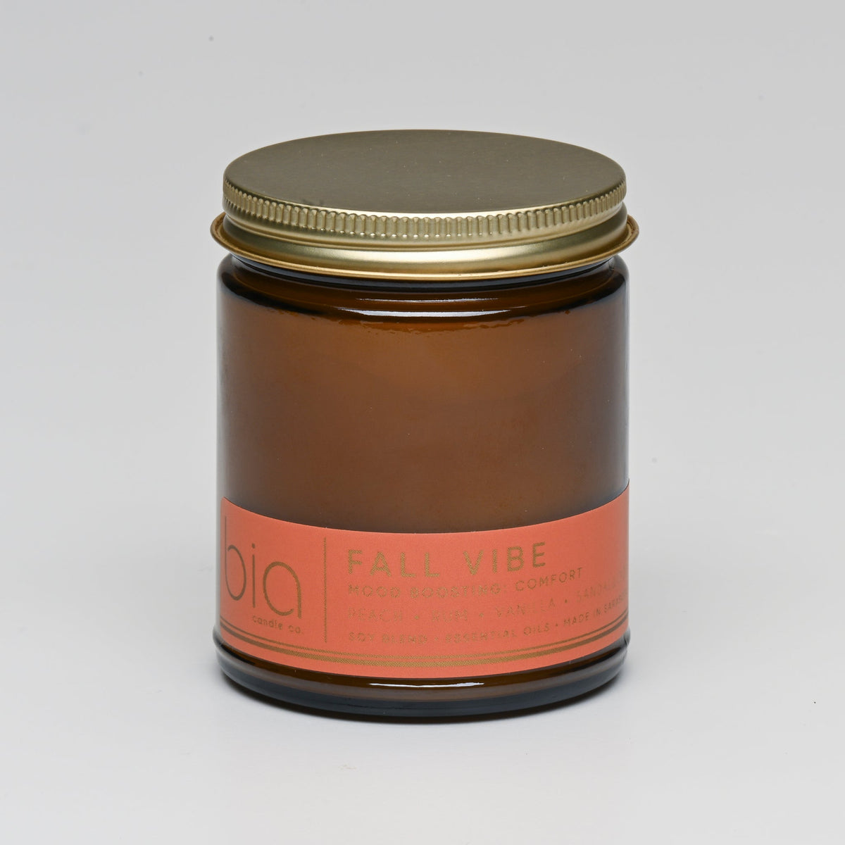 Fall Vibe Classic candle in an amber jar with its gold lid on
