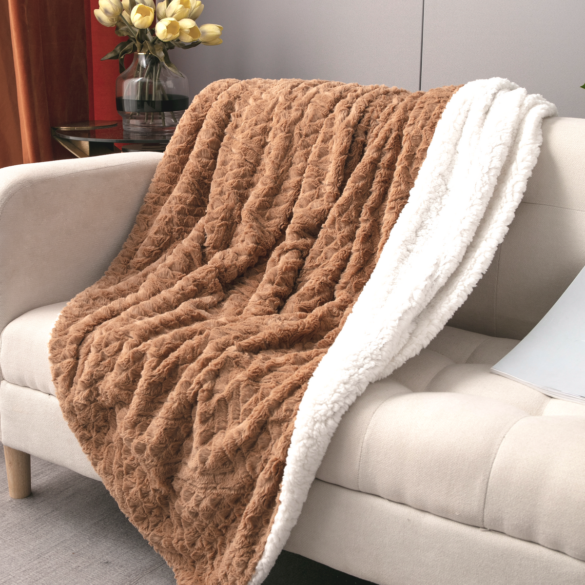 Caramel Chevron throw over the arm of a cream sofa, sherpa side turned out