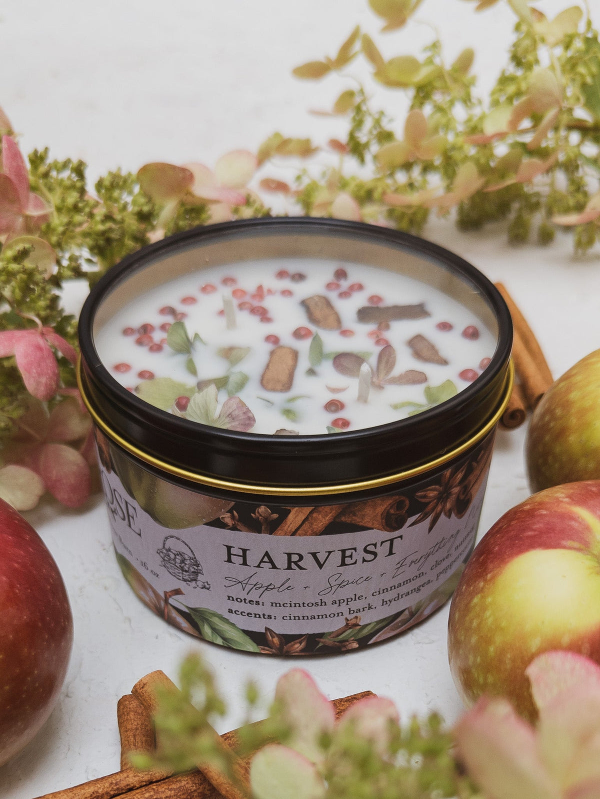 Close-up of a HARVEST apple spice candle tin and its label