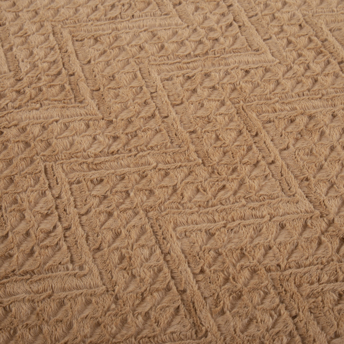 Close-up of the chevron pattern pressed into the caramel faux fur