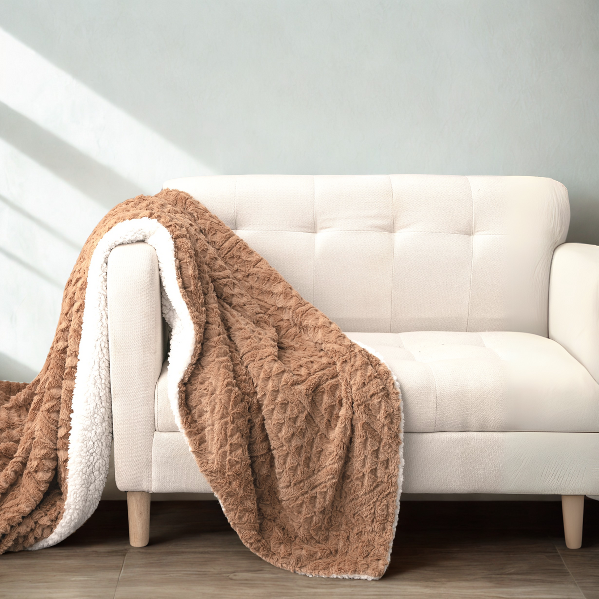 Caramel Chevron throw draped over a cream sofa with the sherpa side showing