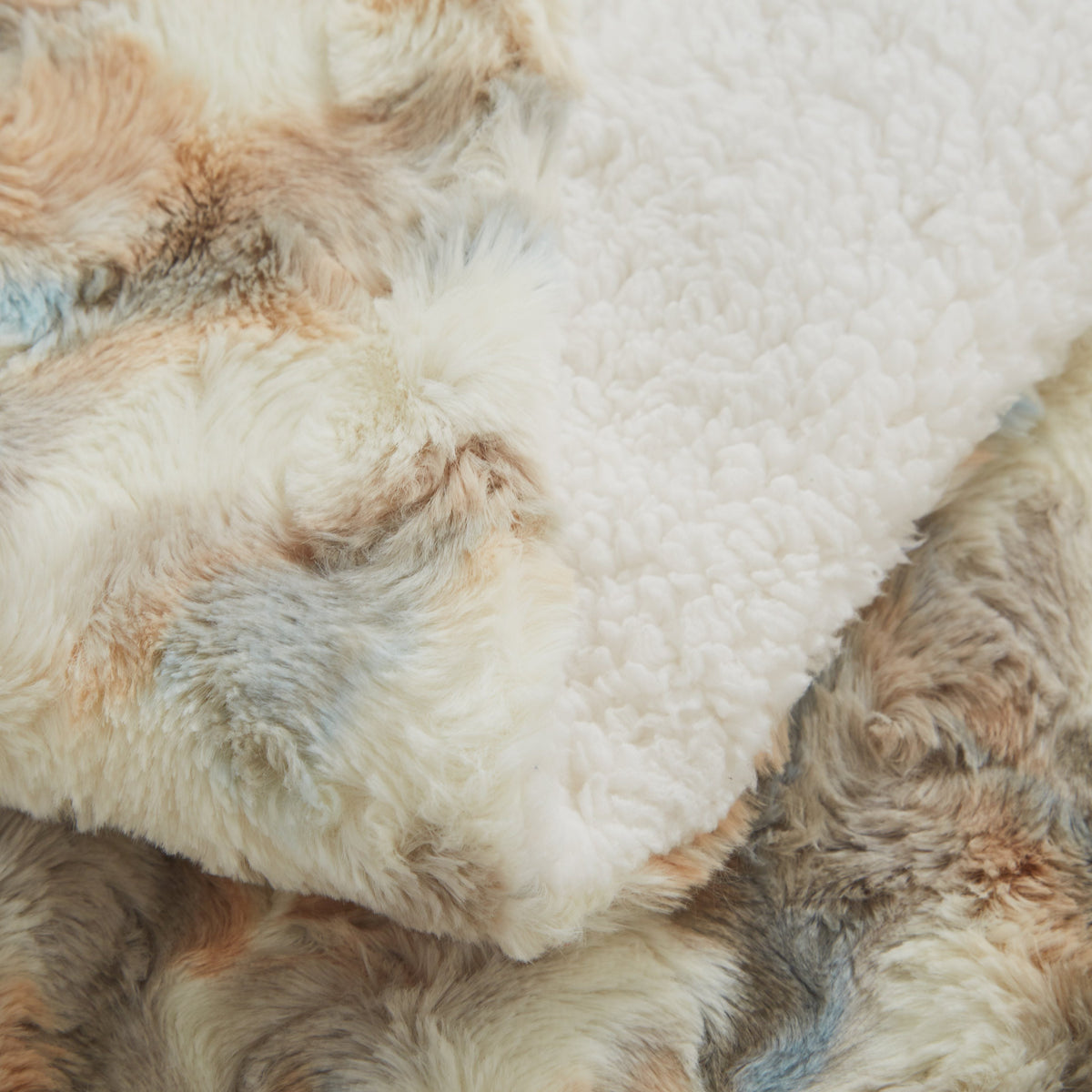 Russian Lynx throw folded to show the faux fur front and sherpa back