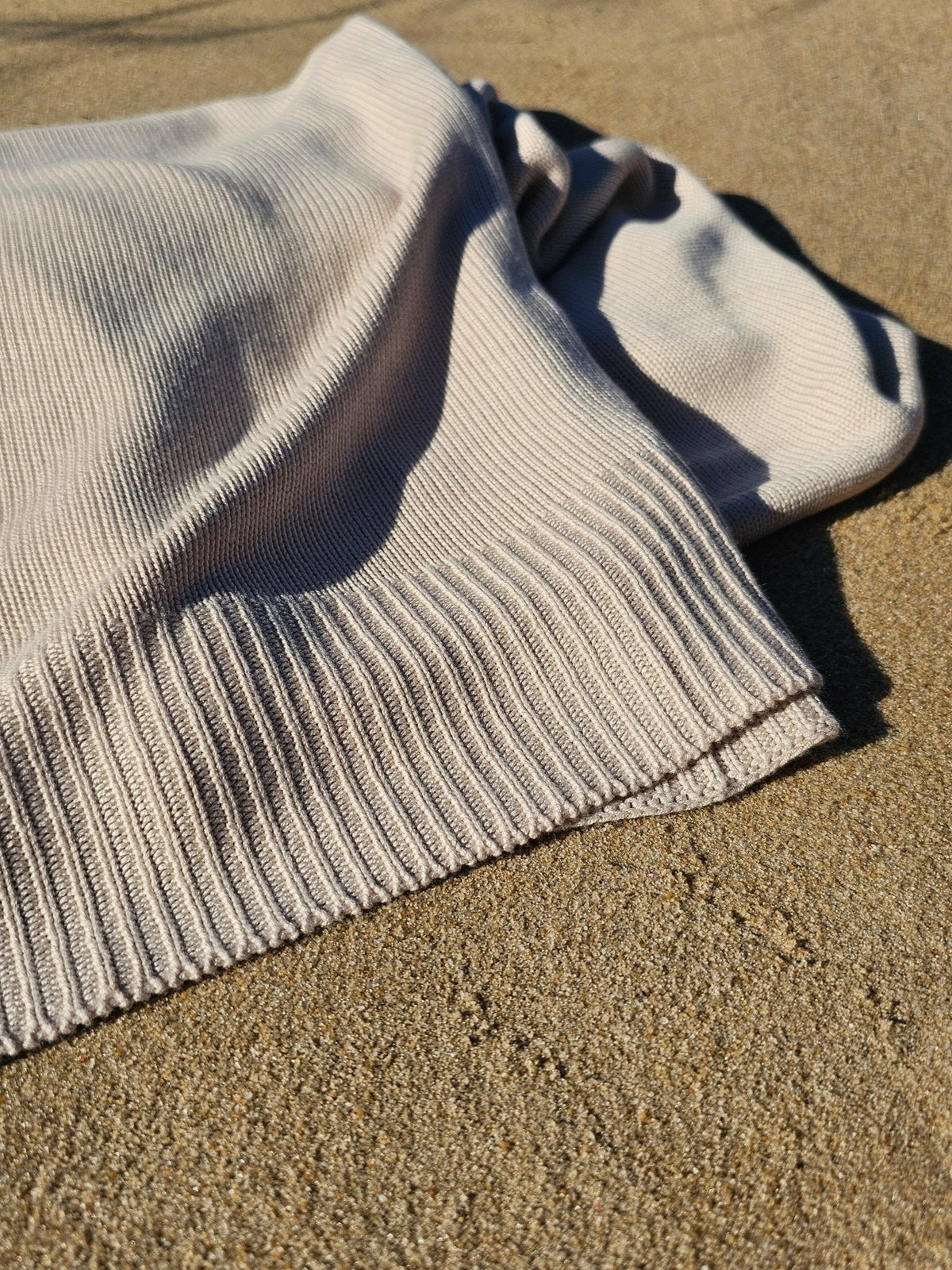 Classic Drift throw tossed on the sand