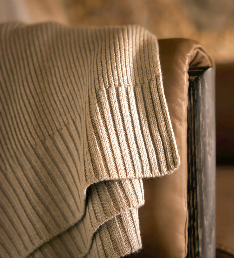 Classic Drift throw in Warm Sand draped over a chair