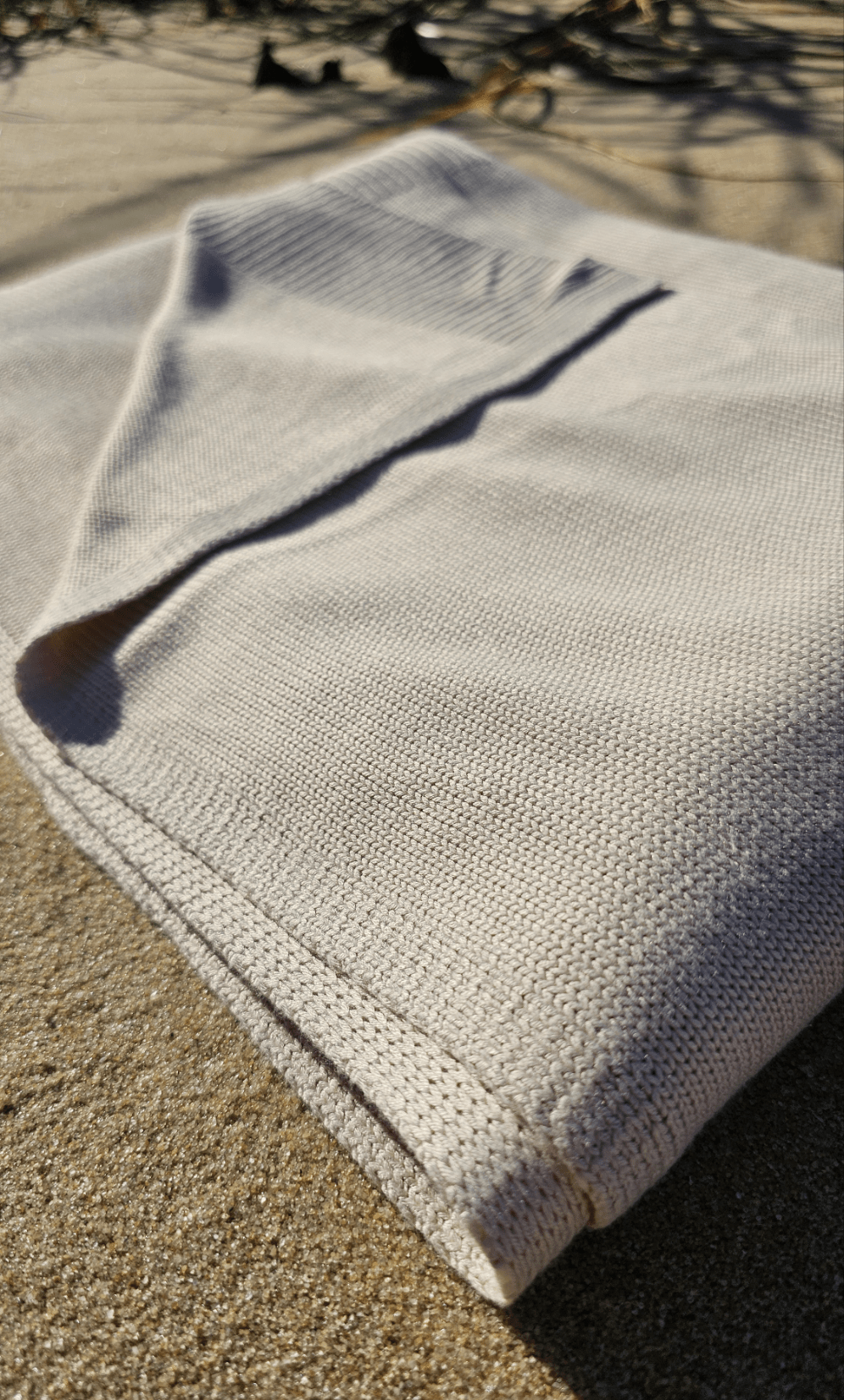 Folded Classic Drift throw on the sand